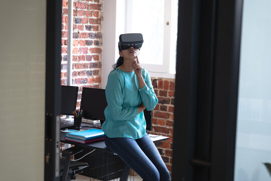 Woman using VR headset at office