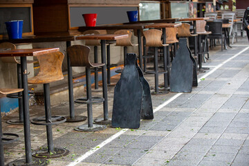 a rainy day Wooden chair standing on leafy path