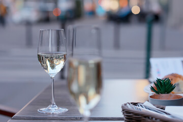 glass white wine restaurant interior, abstract evening dinner with alcohol at the bar