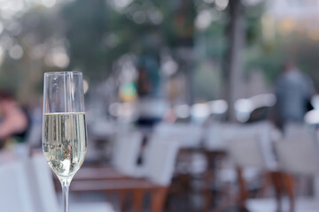 glass white wine restaurant interior, abstract evening dinner with alcohol at the bar