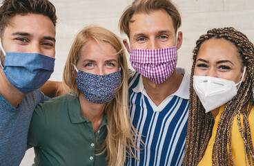 Friends wearing face protective mask to avoid corona virus spread - Young millennial people...