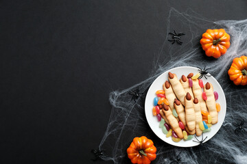 Happy halloween holiday concept. Cookies in form of witches fingers, pumpkins, spiderweb, spiders...
