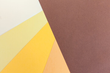 Abstract colorful paper backgroud. Dark brown, beige, orange, yellow and light paper background
