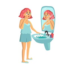 young woman standing in front of mirror. girl with a pimple