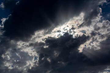 Fototapeta na wymiar Rays of light reflected through the clouds