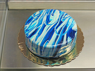 Blue frosting cake in pastry shop