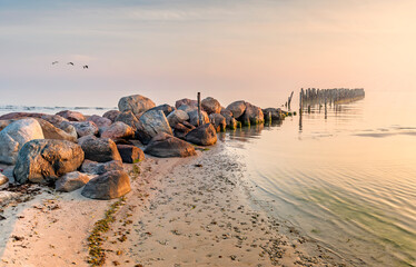 Abandoned old broken pier at Baltic Sea, autumn storm with drops of rain, concept of weather...