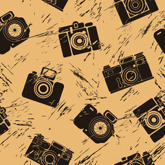 Seamless pattern with photo camera silhouette in old retro style. Repeated vintage pattern with old camera grunge design for wrapping paper, background. Film camera shape on craft paper imitation