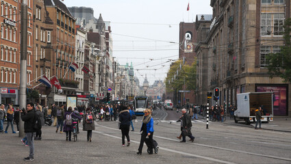 Many people on Damrak street in Amsterdam.
