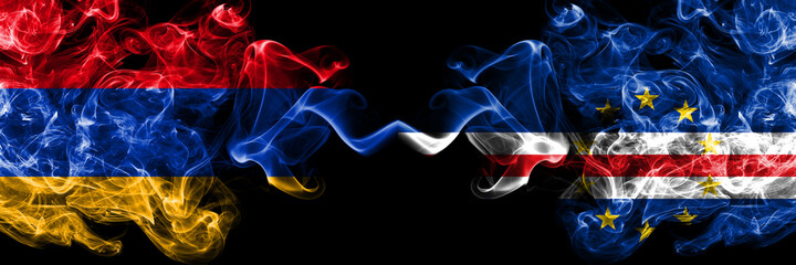 Armenia vs Cape Verde smoky mystic flags placed side by side. Thick colored silky abstract smoke flags