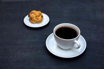 Top view of tea and handmade cookie on black table