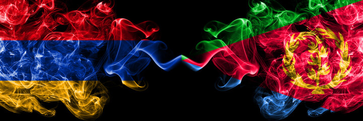 Armenia vs Eritrea smoky mystic flags placed side by side. Thick colored silky abstract smoke flags