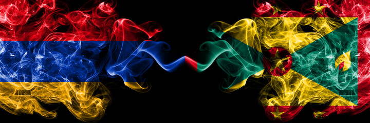 Armenia vs Grenada smoky mystic flags placed side by side. Thick colored silky abstract smoke flags
