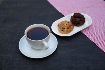 Top view of tea and handmade cookie on black table