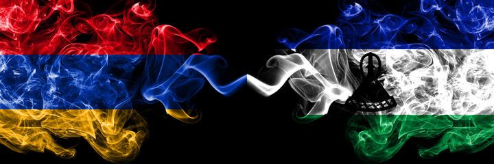 Armenia vs Lesotho smoky mystic flags placed side by side. Thick colored silky abstract smoke flags
