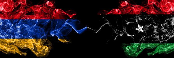 Armenia vs Libya, Libyan smoky mystic flags placed side by side. Thick colored silky abstract smoke flags