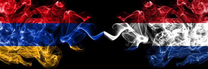Armenia vs Netherlands, Dutch smoky mystic flags placed side by side. Thick colored silky abstract smoke flags