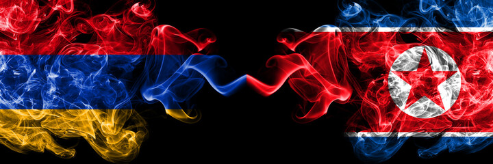 Armenia vs North Korea, Korean smoky mystic flags placed side by side. Thick colored silky abstract smoke flags