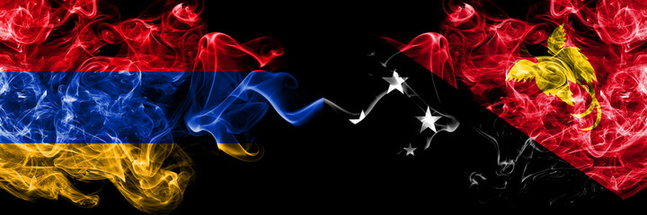 Armenia vs Papua New Guinea smoky mystic flags placed side by side. Thick colored silky abstract smoke flags