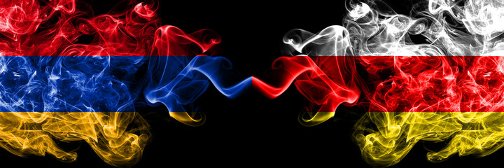 Armenia vs South Ossetia smoky mystic flags placed side by side. Thick colored silky abstract smoke flags