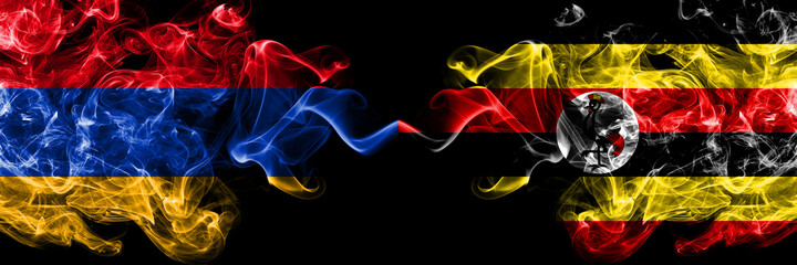 Armenia vs Uganda, Ugandan smoky mystic flags placed side by side. Thick colored silky abstract smoke flags