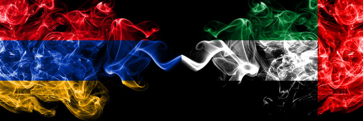 Armenia vs United Arab Emirates, Emirati smoky mystic flags placed side by side. Thick colored silky abstract smoke flags