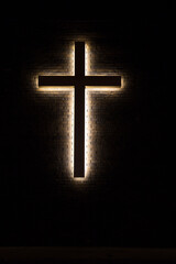 Illuminated Christian Cross in vertical orientation.