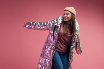 stylish and daring young girl in a silver down jacket