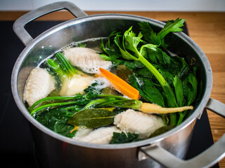 Broth - boiling chicken soup in pot
