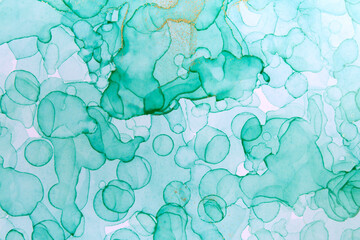 Alcohol ink green and gold abstract background. Drops watercolor texture.