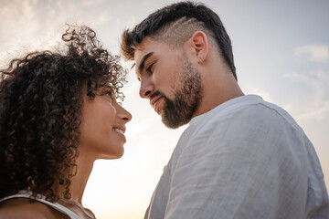 Side view of two young multiethnic passionate lovers looking in the eyes each other - Macho bearded...
