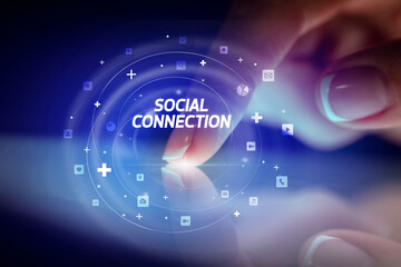 Finger touching tablet with social media icons and SOCIAL CONNECTION