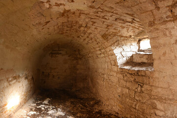 Old cellar in the castle. Daylight shines through the window.
