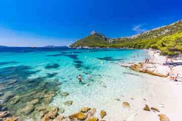 Platja de Formentor, Mallorca, Spain - July 20, 2020: People enjoying popular beach in summer, Mallorca, Spain.