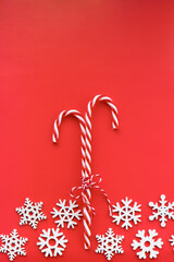 candy canes and bow on red background