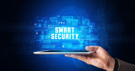 Young business person working on tablet and shows the digital sign: SMART SECURITY