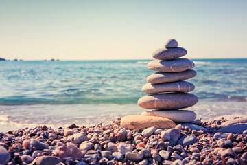 Fototapeta na wymiar Spa gray stones balance on summer beach.