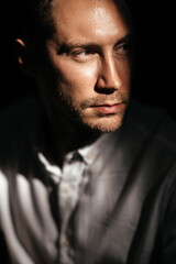 Obraz premium young attractive man looking and thinking. portrait of handsome man sitting in cafe