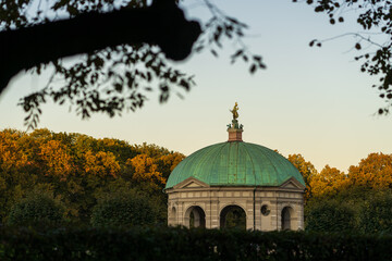 Munich hofgarden cathedral during sunset, framed by trees