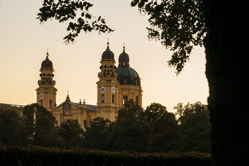 Theatiner Church Munich during sunset, framed by trees