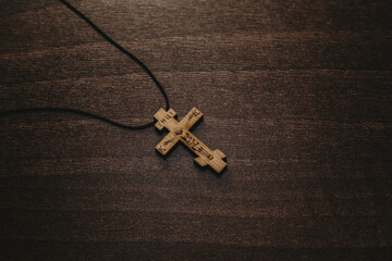 cross on brown wooden table background