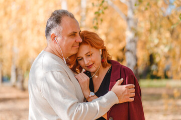 Fototapeta premium middle-aged man and woman with headphones