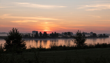 sunrise over the river maas in Holland