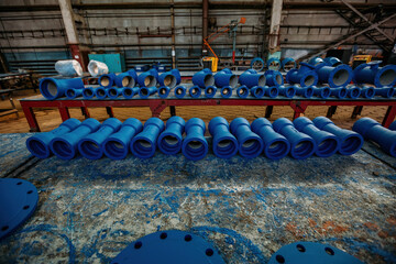 Cast metal blue pipe connection parts at workshop