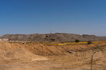 Suburban industrial zone. Industrial waste. Mountains of waste from a phosphorus plant. Industrial landscape. Factory pipe. Ecological problem