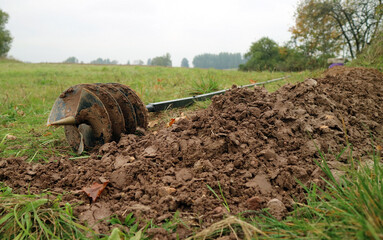 Manual auger used for drilling a well by hand