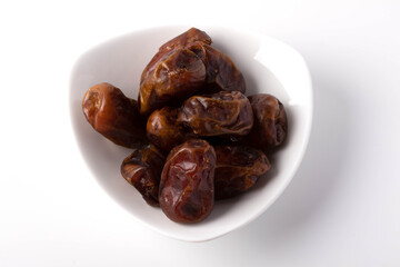 Date palms stacked on a white background