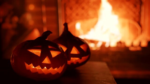 Halloween. Video image of two pumpkins on the background of the fireplace.
