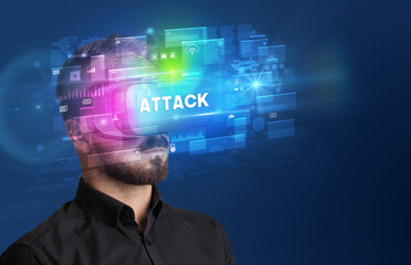 Businessman looking through Virtual Reality glasses with ATTACK inscription, innovative security concept