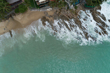 Aerial view of crashing waves on rocks landscape nature view and Beautiful tropical sea with Sea coast view in summer season image by Aerial view drone top down view.